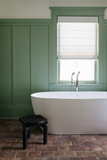 mint green bathroom color and brown floor tiles and freestanding tub