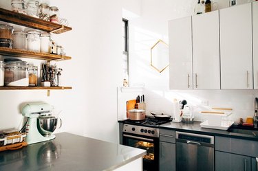 small kitchen with stainless steel countertops and open shelving