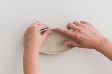 Smooth the edge of the dish with your finger and some water.