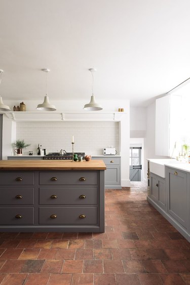 English country kitchen with brick flooring and island