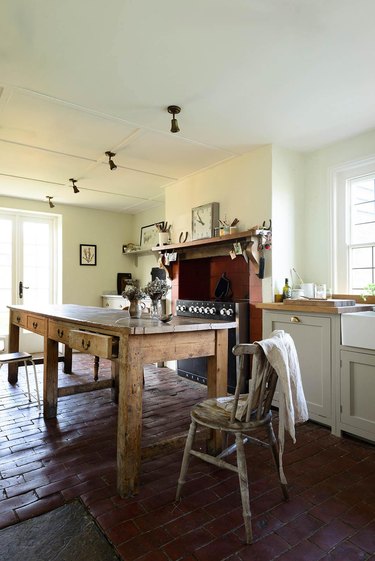 country kitchen with brick flooring and marble countertops