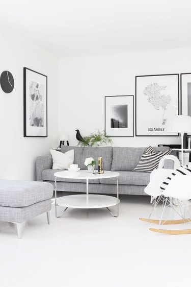 white living room with gray sofa and black accents