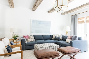 white living room with rustic wooden beams across the ceiling