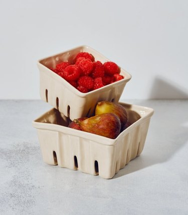 two ceramic berry baskets with fruit