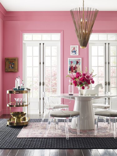 dining room area with bright pink wall