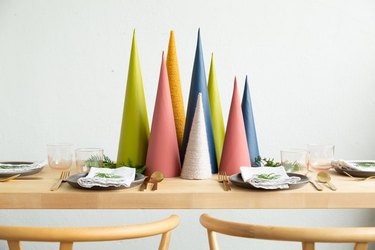 Modern Christmas decor with green, pink, orange, white and blue thread-covered Christmas tree centerpiece