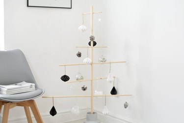 Modern Christmas decor with wood Christmas tree with black, white and silver ornaments