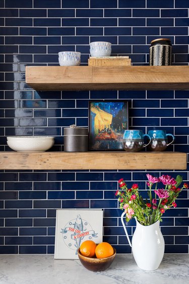 small kitchen design with blue subway tile backsplash and wood shelving