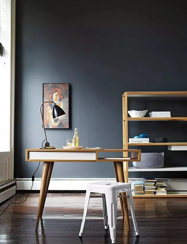 Feng Shui Home Office with midcentury desk and dark wall