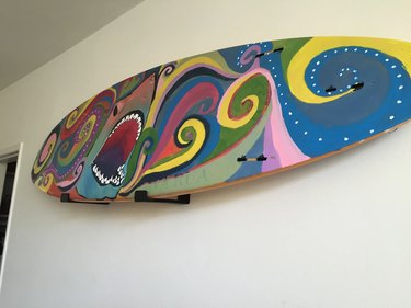 Surfboard hung on wall.