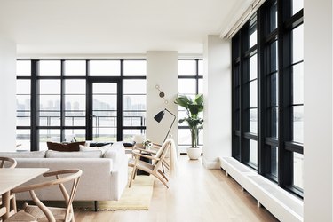 white living room with floor to ceiling windows