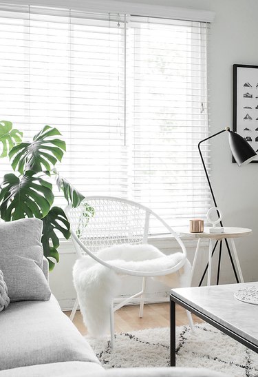 white living room with black accents and area rug