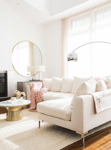 white living room with sectional sofa and high ceilings