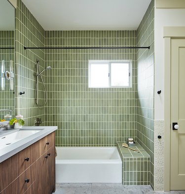 green minimalist shower with rectangular tile and walnut. vanity
