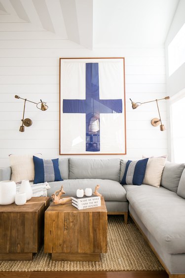 white living room with sectional sofa and shiplap walls