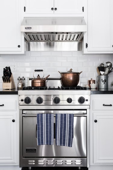 Viking stove in white traditional kitchen with copper pots