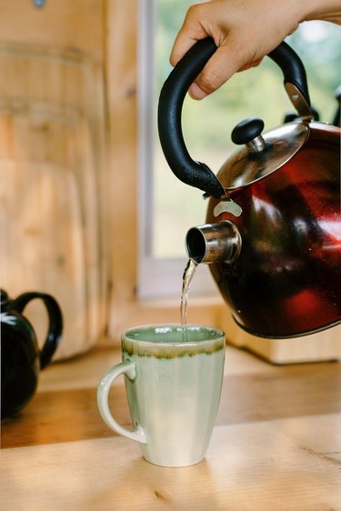 Tea kettle pouring hot water