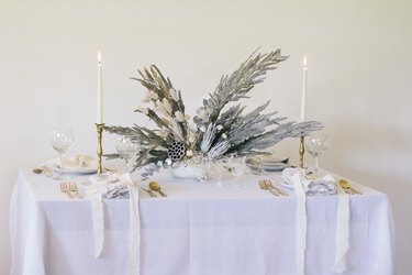 Silver holiday floral centerpiece with pampas grass