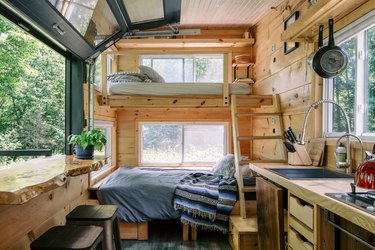 Cabinscape cabin interior of loft bed and kitchen