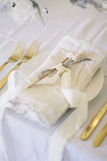 Flowers tied with ribbon on place setting