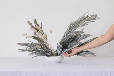 Placing protea flowers into vase