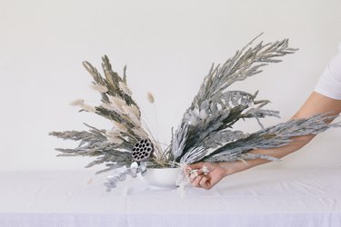 Placing baby's breath into vase