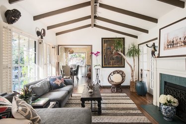 Bohemian living room with gray furniture and wood beams