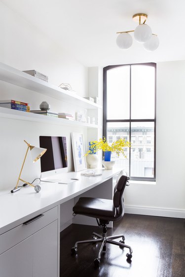 white modern home office with built-in desk and shelving