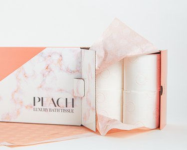 toilet paper package with text that reads "peach luxury bath tissue"