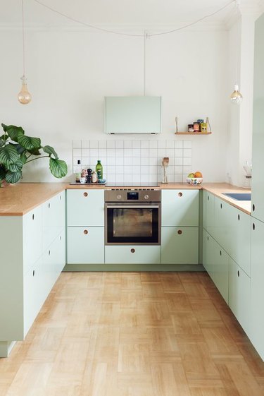 neo mint kitchen with wooden countertops and white tiles