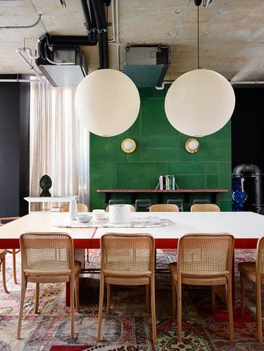 dining space with green tile accent wall