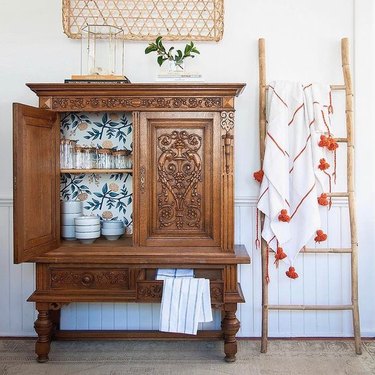 vintage cabinet lined with removable wallpaper