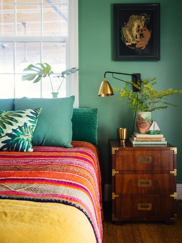 green bedroom with red Southwestern blanket