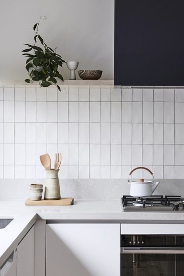 simple gray and white kitchen with tile backsplash and stainless steel appliances