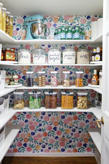 back wall of pantry lined with removable wallpaper