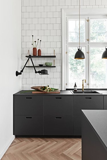 black and white kitchen with charcoal linoleum cabinetry