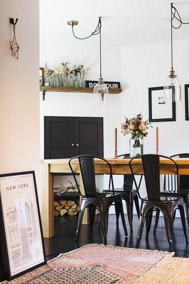 industrial dining room idea with iron chairs and exposed glass lighting
