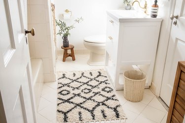 Moroccan tassel rug and woven waste can in DIY bathroom makeover