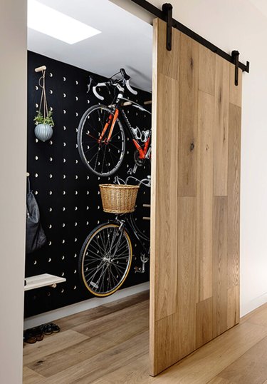 Light wood Contemporary Barn Doors, bicycle storage, skylight.