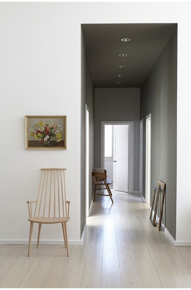 A hallway with subtle Scandinavian vibes, dark paint, and cool tones.