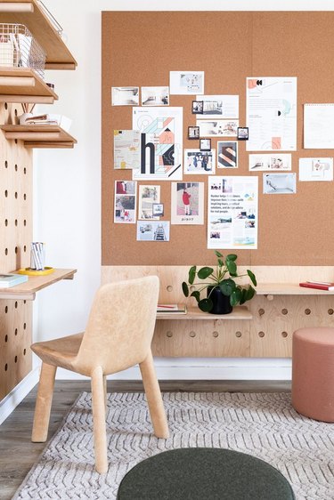 contemporary office space with custom-built pegboard wall unit