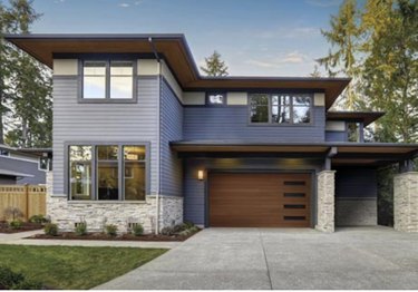 modern home with streamlined wooden garage door