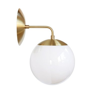 L-shaped brass sconce with white globe light