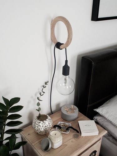bedroom lighting idea with pendant wrapped around a wall hook at bedside