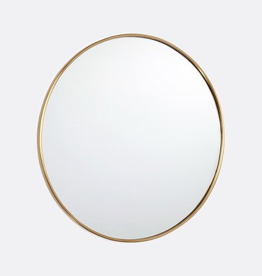 Round mirror with thin brass border