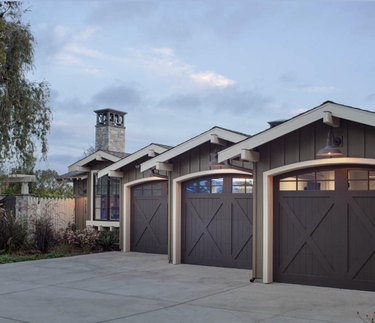 Dark brown barn garage doors showcased on modern farmhouse exteriors