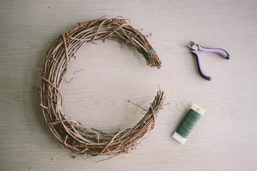 Ends of grapevine wreath tied with floral wire and shaped into crescent moon