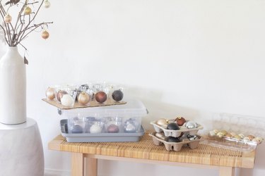 Ornaments stored inside plastic cups, drink holders and egg cartons