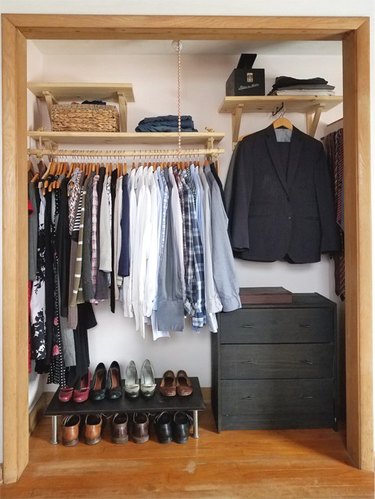Open bedroom closet idea by Little Victorian with open shelving and hanging clothes