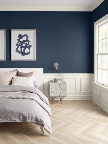 bedroom with navy walls and white trim